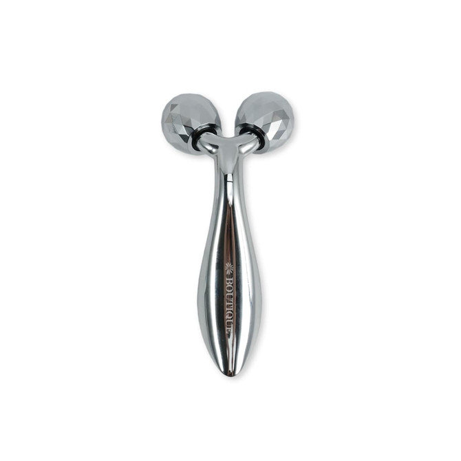 A silver facial roller with two textured heads, featuring a sleek design and a branding logo.