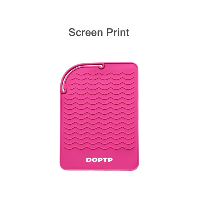 A pink silicone hair straightener pad with a wavy texture and a hanging loop at one end.