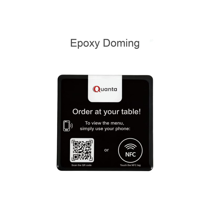A black NFC epoxy desk tag with a QR code and a logo, designed for food ordering at tables.