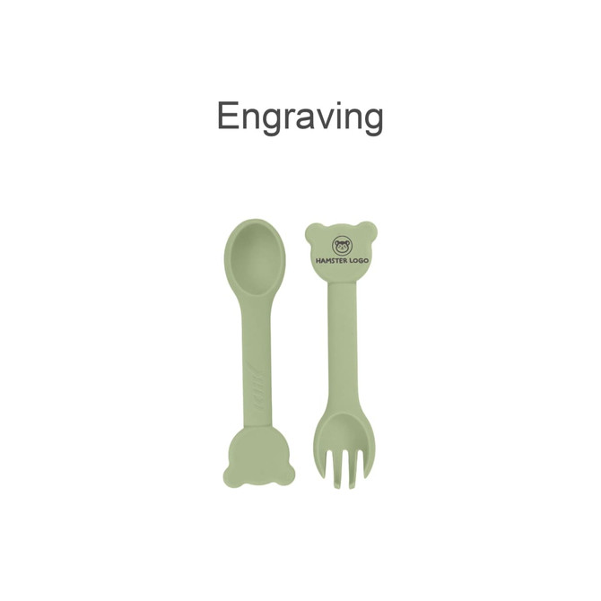 A bear-shaped silicone kids cutlery set in soft green, featuring a spoon and fork, with a small logo.
