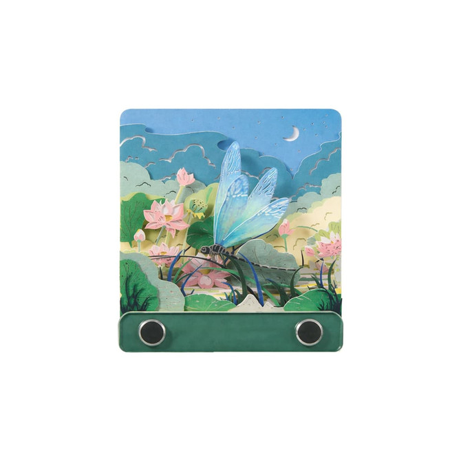 A 3D paper-cut sculpture notepad with a blue dragonfly design and a green base, featuring floral and landscape elements.