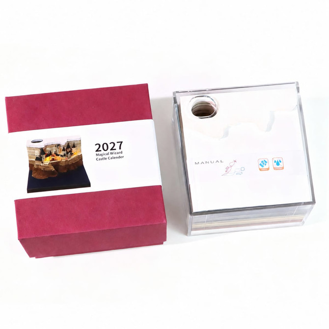 A 3D paper carving notepad weekly calendar in a clear acrylic case with a red box packaging.