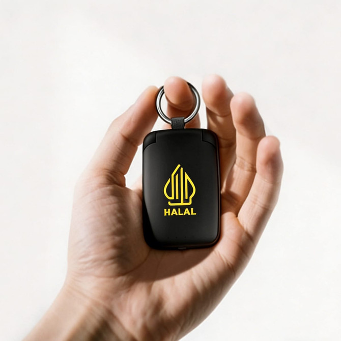 A black mini power bank with flashlight features a keyring attachment and a logo on the front.