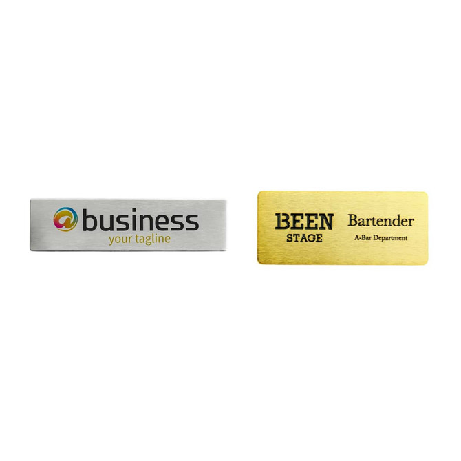 Two metal name badges, one silver and one gold, featuring different designs and a logo on each.