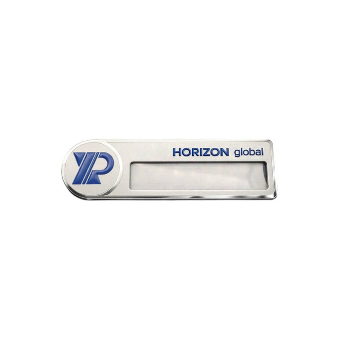 A silver metal name badge with a blue logo, featuring a clear section for displaying names.