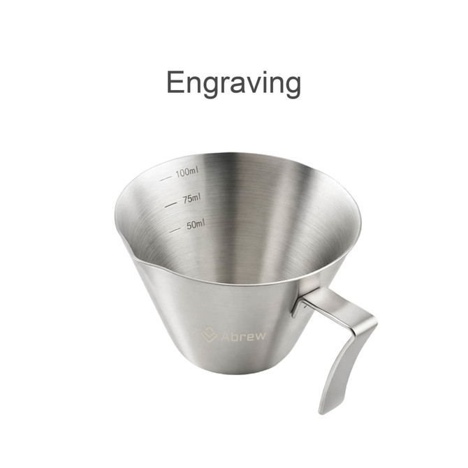 A stainless steel espresso measuring cup with measurements marked inside, featuring a handle and a logo.