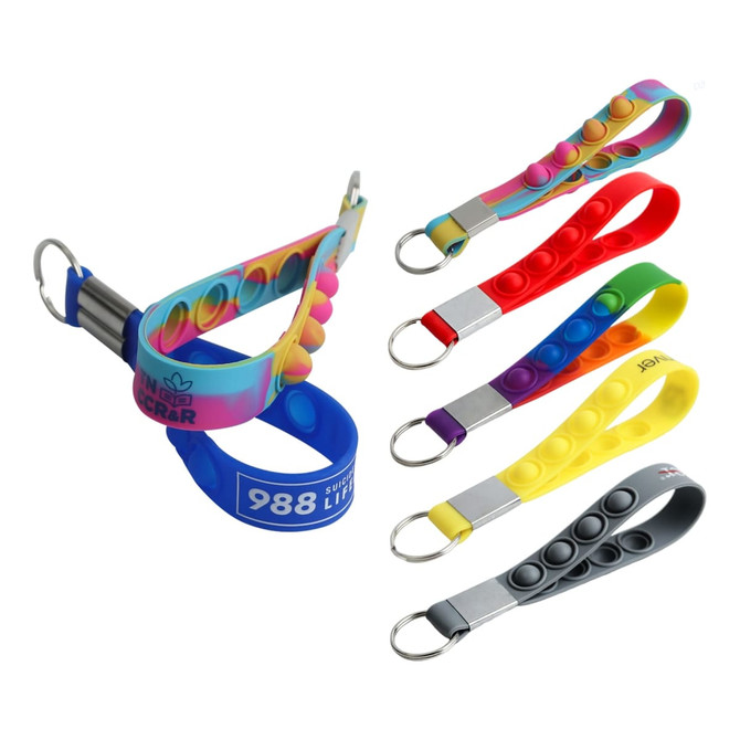 A set of colourful popper stress reliever keyrings in various colours, including rainbow, red, yellow, and grey.