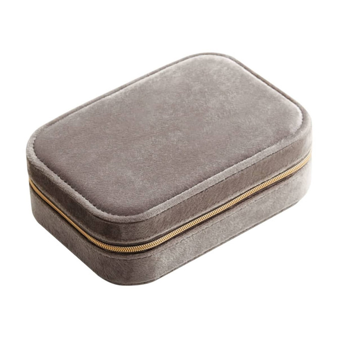 A grey velvet jewellery box with a compartment and a zip closure. It features a subtle texture and a gold zipper.