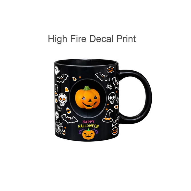 A black ceramic coffee mug featuring a spooky Halloween design with skeletons, bats, and a smiling pumpkin spinner toy.