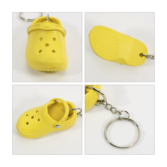 A yellow clog shoe keyring featuring decorative cut-outs and a silver keyring attachment. Includes a textured sole design.