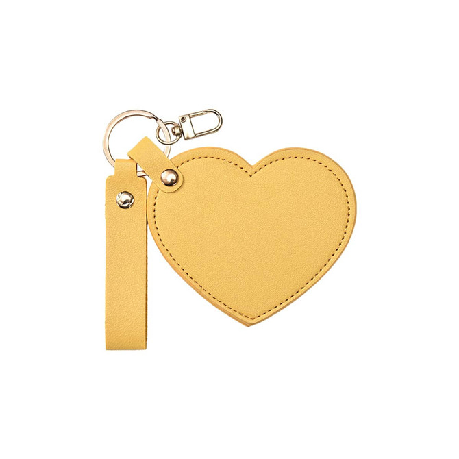 A heart-shaped compact mirror in yellow with a keychain attachment and a strap.