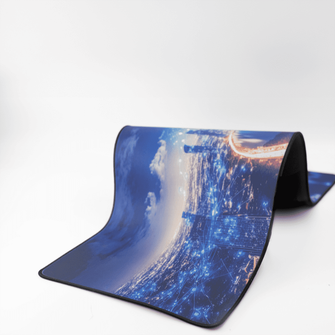 A rubber desk mat featuring a blue and grey city skyline design with digital network motifs.