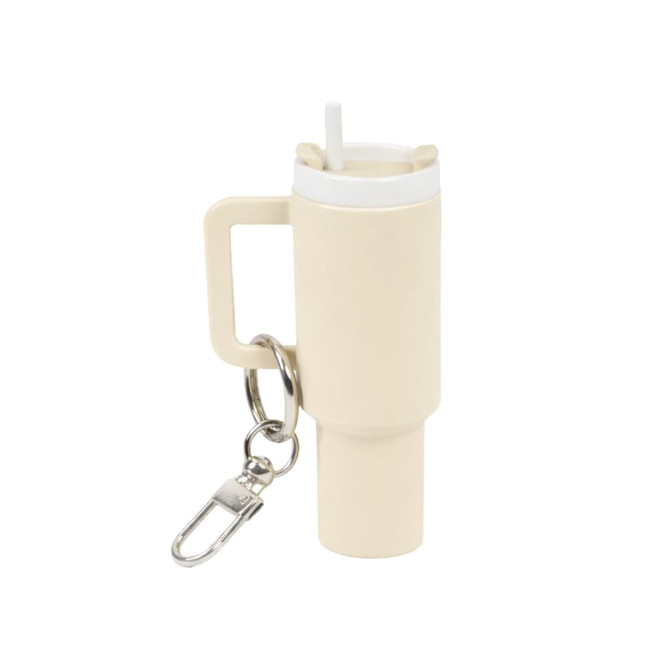 A drink bottle keyring in a soft cream colour with a straw and a handle, featuring a small keychain attachment.