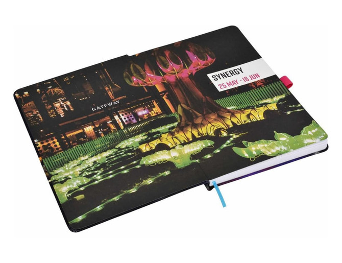 A soft-touch A5 notebook with a vibrant cover design featuring colours of green, pink, and black, plus a bookmark.
