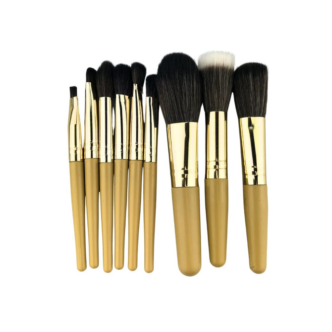 A set of nine makeup brushes with gold handles and varying brush types, presented in a neat arrangement.