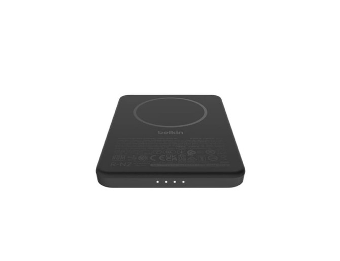 A black power bank featuring a circular charging area and three indicator lights, with branding present.