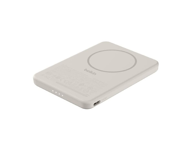 A slim, cream-coloured power bank with a circular area, featuring a logo and indicator lights.