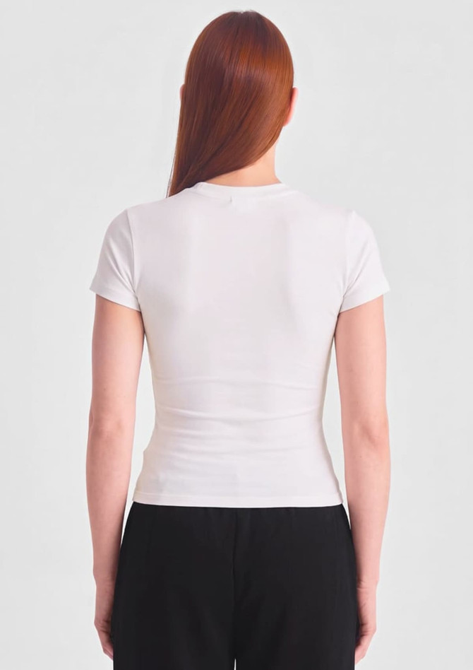 A white women's baby tee featuring short sleeves and a fitted design, shown from the back.