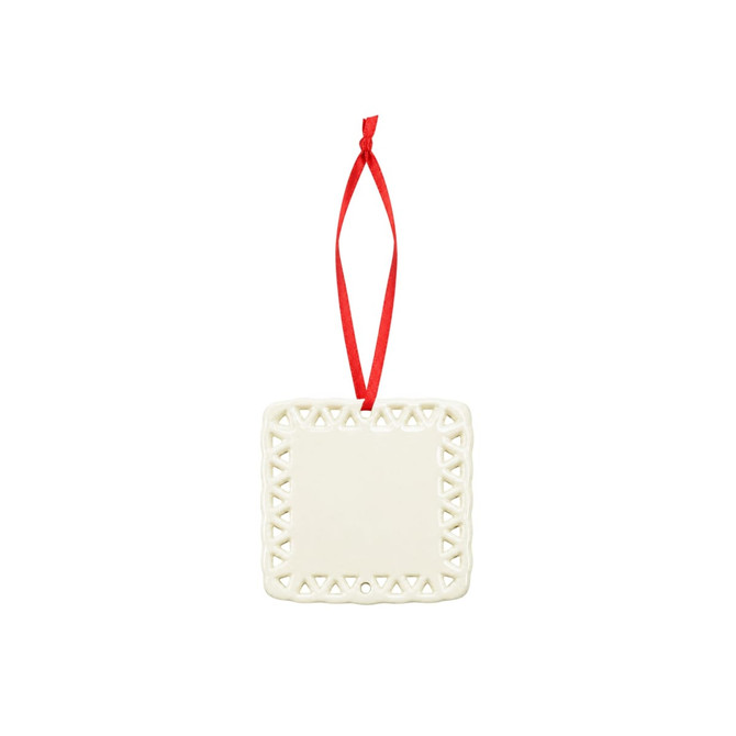 A ceramic ornament in white with a decorative lace-like border and a red hanging ribbon.