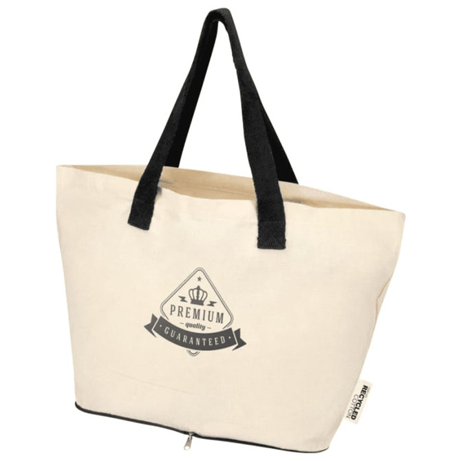 A cream foldable tote bag with black handles and a logo on the front, made from recycled cotton.