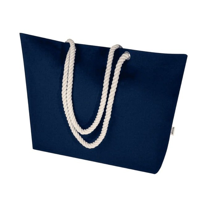 A navy blue beach tote bag with white rope handles and a branding logo.