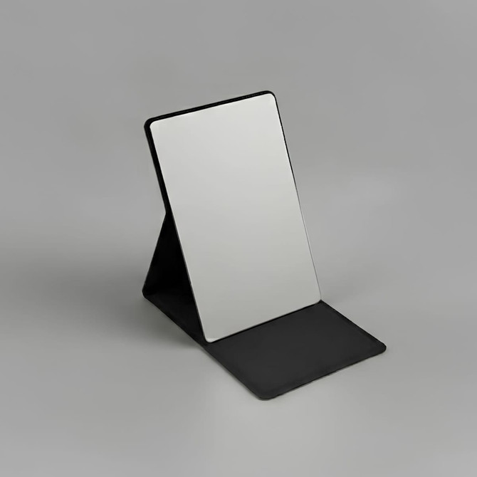 A compact mirror with a sleek black stand, featuring a reflective surface and a minimalist design.