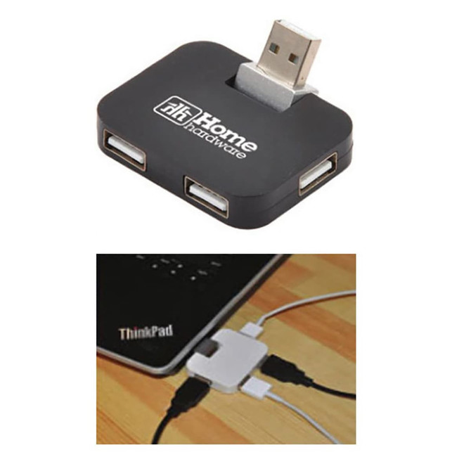 A black USB hub featuring multiple ports, with a logo, positioned near a laptop and connected cables.
