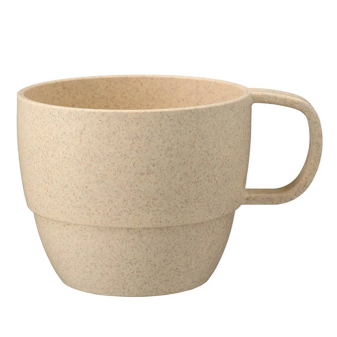 A reusable coffee cup in a light beige shade with a handle and a textured finish, featuring a brand logo.