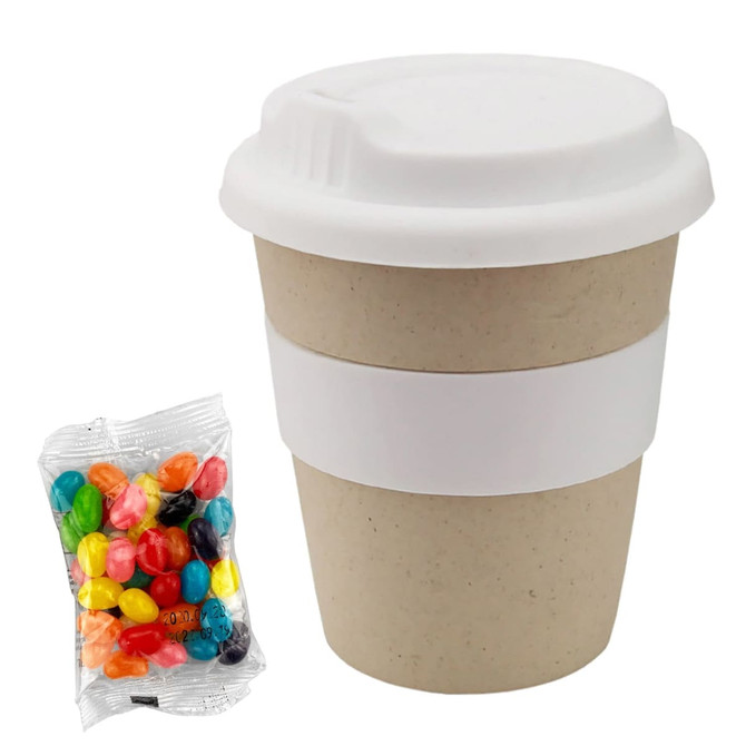 A bamboo cup in natural colour with a white lid, accompanied by a packet of colourful jelly beans.