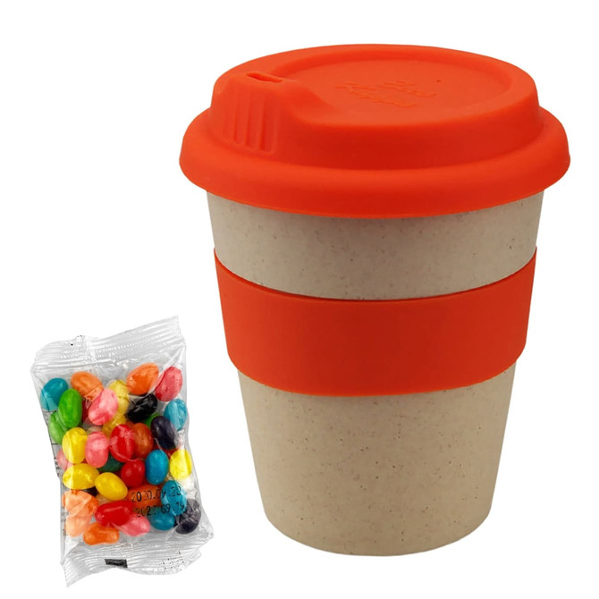 A bamboo cup in natural tones with an orange lid and sleeve, alongside a packet of colourful jelly beans.