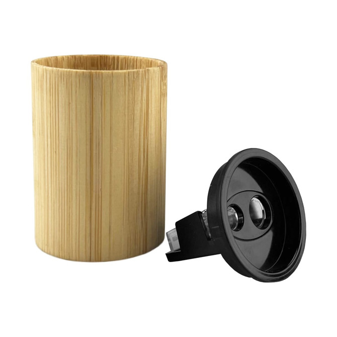A bamboo pencil sharpener in a cylindrical shape with a black sharpening mechanism. The natural bamboo texture is visible.