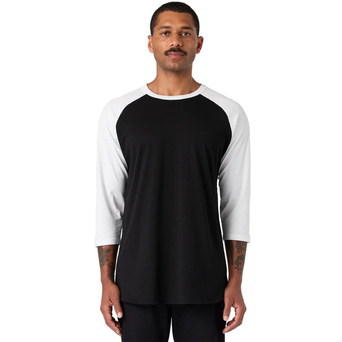 A black and white raglan tee shirt, featuring three-quarter sleeves and a casual fit, worn by a model.