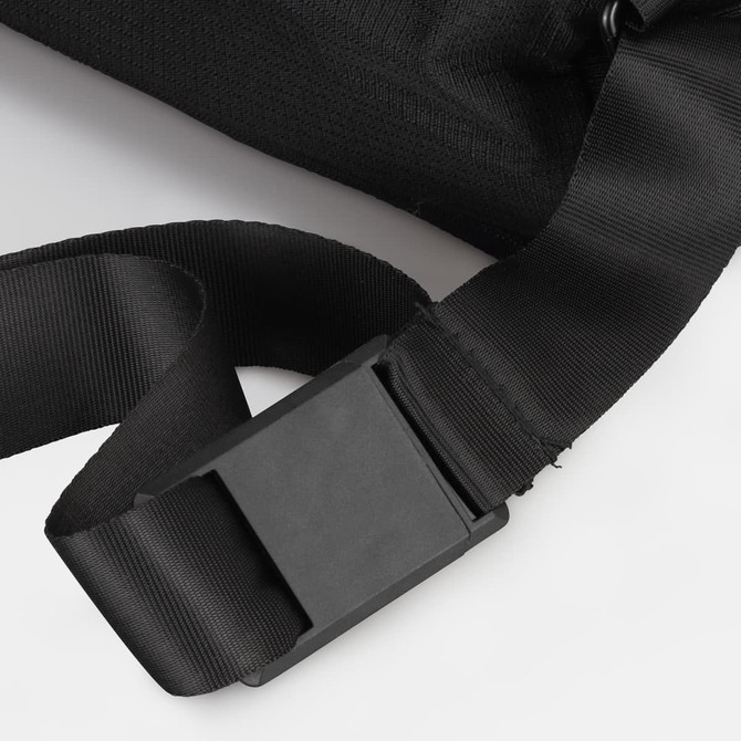 A black sling bag featuring a sturdy strap and buckle closure, with a textured fabric surface.