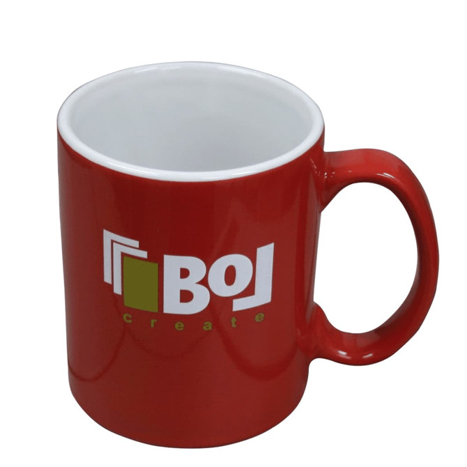 A red ceramic mug with a white interior and a logo, packaged in a folded box.