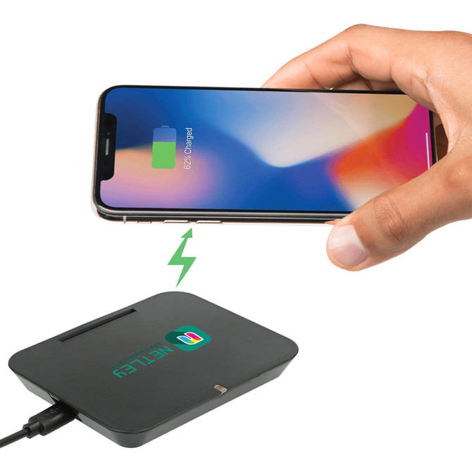 A black wireless charging phone stand with a connected cable, and a smartphone above it showing a charging icon.