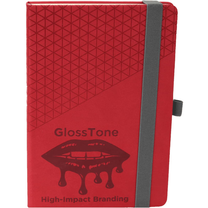 A red notebook with a geometric design, featuring a grey elastic band and a logo on the front.
