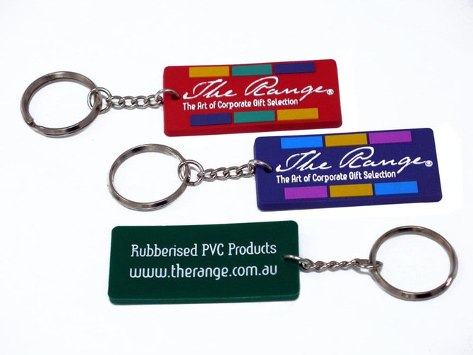 A set of three custom PVC keyrings in red, purple, and green, featuring a metal chain and keyring attachment.