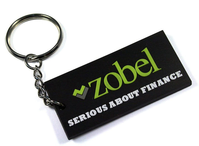 A black custom PVC keyring with a silver keychain, featuring green and white branding elements.