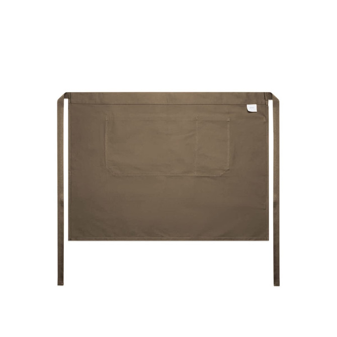 A khaki half apron featuring a front pocket and ties at the waist. It has a simple, minimalist design.