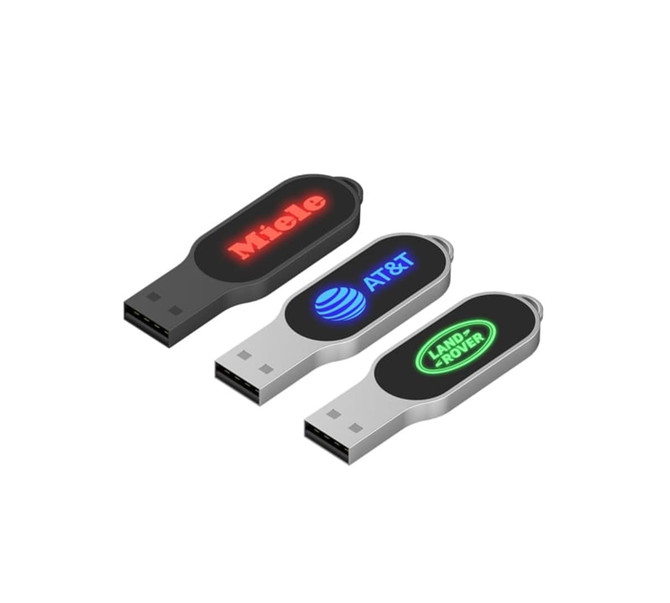 Three LED flash drives in black and silver, featuring logos on their sides in red and green illumination.