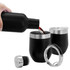 A drink bottle in matte black pouring liquid into a black wine tumbler with a silver rim and lid.