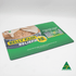 A green counter mat featuring an illustrated design for belly pain relief with a logo, measuring 420mm x 297mm x 1mm.