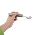 A stainless steel camping cutlery tool held in a hand, featuring multiple utensils and a logo.