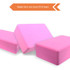 Three pink EVA yoga blocks made from non-toxic foam, arranged in varying angles against a white background.