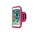 A pink cell phone arm band holding a smartphone, designed to secure the device during activities.