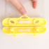 A yellow waterproof mobile pouch with a sealing mechanism, held by a hand. Features clear sides for visibility.