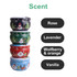 A set of four tin candles in green, red, blue, and white, each featuring festive designs and distinct scents.