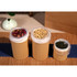 Three medium brown paper cylinder boxes of varying heights, each with a transparent plastic lining, containing floral petals, soybeans, and tea leaves.