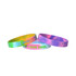 Three marble-coloured silicon wristbands in vibrant hues of pink, green, and yellow, featuring different logos and designs.