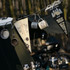 A black and cream felt pennant hanging alongside camping mugs and other camping gear, set outdoors.